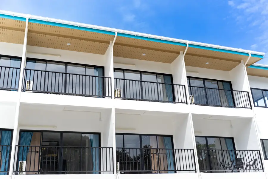 The hostel balconies in a row, teal roofline against the sky