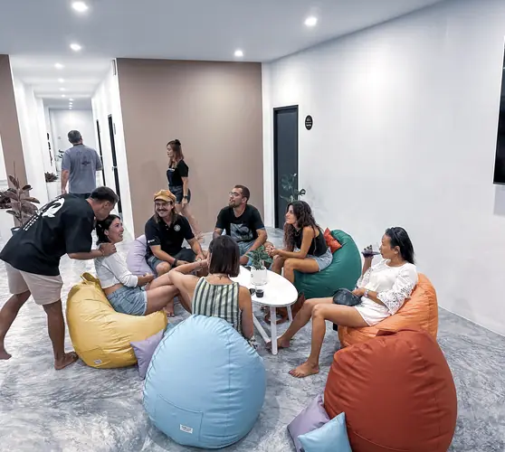 Guests sitting in a circle on the bean bags in the shared lounge