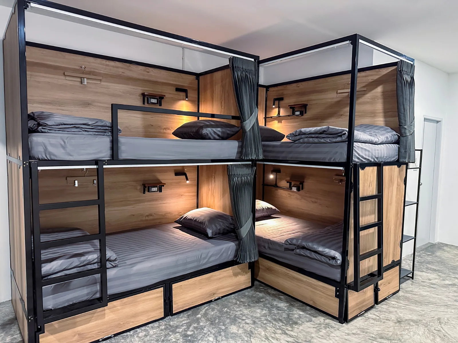 Four bunks in an L-shaped layout, bright and freshly made