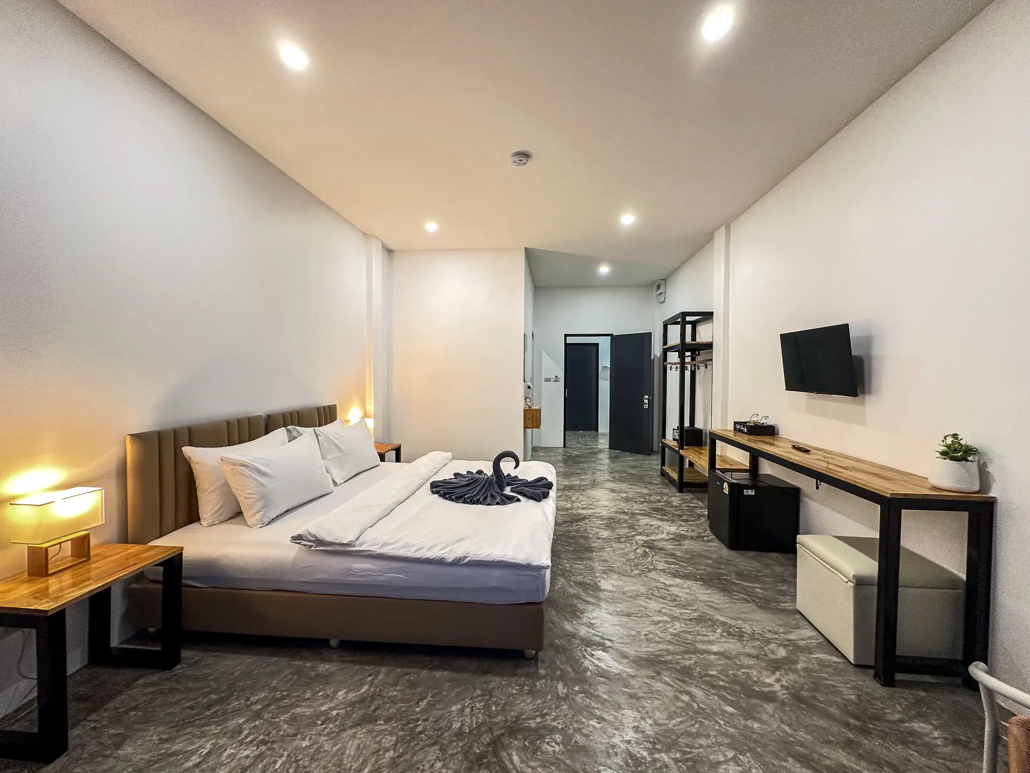 Twin beds with bedside lamps and balcony opening onto the jungle hillside